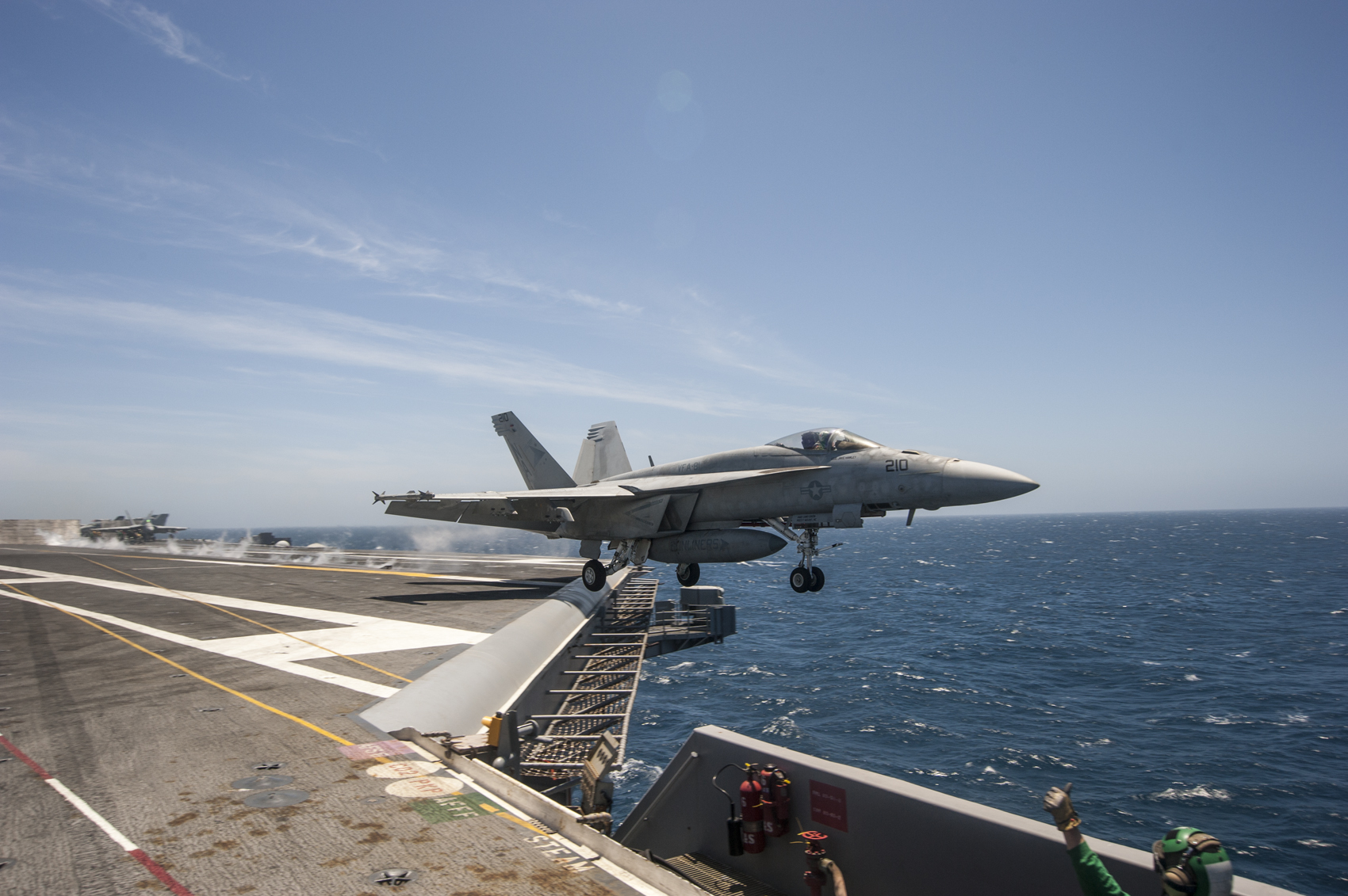 This is an image of an F/A-18E Super Hornet launching from a flight deck.